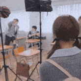 a girl with pigtails and a backpack stands in front of a camera