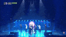 a group of young men are performing on a stage with the words my k-festa on the bottom left