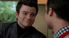 two men are looking at each other and one of them is making a funny face