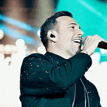 a man singing into a microphone while wearing headphones