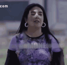 a woman in a purple shirt with the word ramones on it