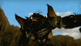 a robot is standing in front of a mountain with a blue sky behind it .