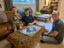 two men and a boy are playing a board game together
