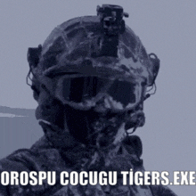 a soldier is wearing a helmet and goggles and says orospu cocugu tigers.exe on the bottom