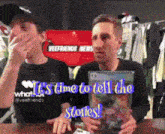 two men are sitting in front of a sign that says " veefriends news "