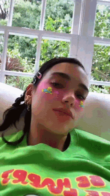 a woman is wearing a green shirt that says yeah 30 on it