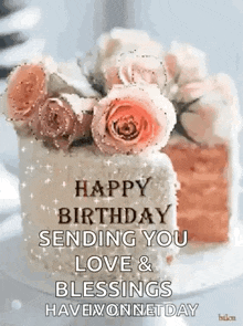 a birthday cake with roses on top of it and the words `` happy birthday sending you love and blessings have a wonderful day '' .