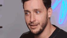 a close up of a man 's face with a beard
