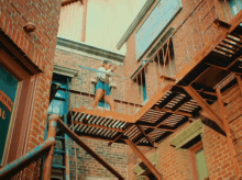 a woman is standing on a fire escape in front of a building that has a sign on it that says mystery theatre