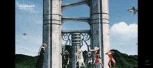 a group of ultraman characters are standing in front of a tower