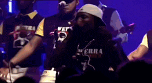 a man singing into a microphone wearing a shirt that says terra