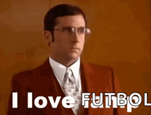 a man wearing glasses and a suit says i love futbol