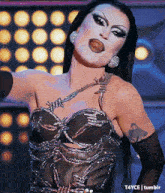 a woman with a tattoo on her arm is wearing a black top