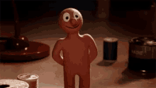 a cartoon character is standing on a table with his hands on his hips and a can of soda in the background .