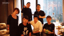 a group of people are posing for a picture and one of them is wearing a shirt that says bad