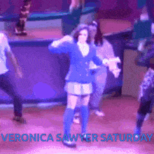 a picture of veronica sawyer saturday with a woman in a blue dress