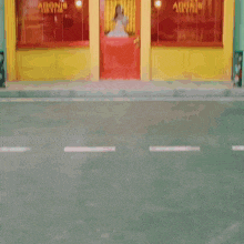 a woman in a white dress stands in front of a adonis nail salon