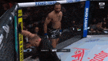 a man in a ufc ring with a bud light banner