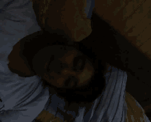 a person laying on a bed with a striped blanket