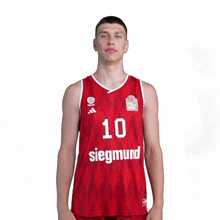 a man wearing a red siegmund basketball jersey