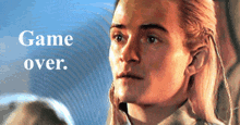 a close up of a man 's face with the words game over written above him
