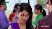 a woman in a purple and green dress stands next to a man in a star plus hd ad