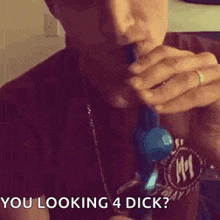 a man is smoking a cigarette with smoke coming out of his mouth and says `` you looking 4 dick '' .