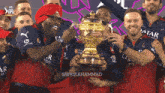a group of players holding a trophy with qatar airlines on their shirts