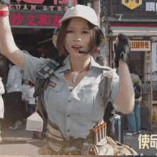 a woman stands in front of a store that says yuan street on it