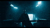 a man in a batman costume is standing in a dark room .