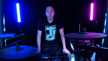 a man wearing a shirt with the letter j on it
