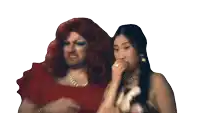 a drag queen is standing next to a woman who is covering her mouth with her hand