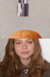 a woman 's face is split in half with an orange being poured on it .