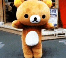 a teddy bear is standing in front of a store with chinese writing on it