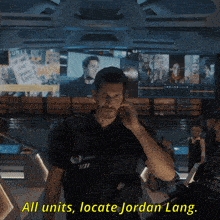 a man in a police uniform talks on a cell phone with the words all units locate jordan lang above him