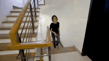 a woman walking down a set of stairs