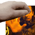 a close up of a person 's hand reaching out towards a man 's face .