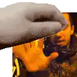 a close up of a person 's hand reaching out towards a man 's face .