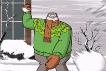 a man in a green sweater and scarf is throwing a snowball in the air