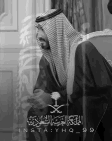 a black and white photo of a man in a traditional arabic dress