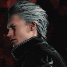a man with gray hair and a black jacket is standing in the dark .