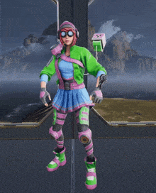 a girl in a green jacket and pink skirt is standing on a platform