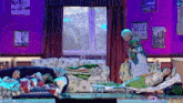 a group of people laying on a couch with a woman standing behind them
