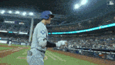 a baseball player wearing a blue helmet with the letter g on the back of his jersey