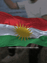a red white and green kurdish flag with a yellow star on it