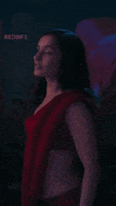 a woman in a red crop top and a red saree with the words redgifs on the bottom