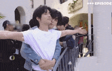 a group of young men hugging each other in front of a sign that says charles mint