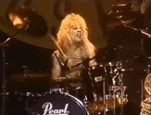 a person playing drums with a pearl drum set