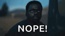 a man in a dark room with the word nope written on it