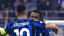 two soccer players hugging one of whom has the number 10 on his jersey